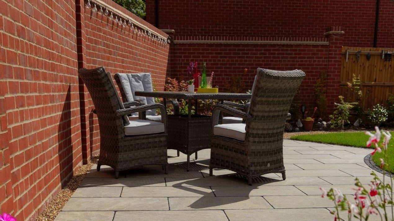 Garden furniture in a sunny spot by the lawn.
