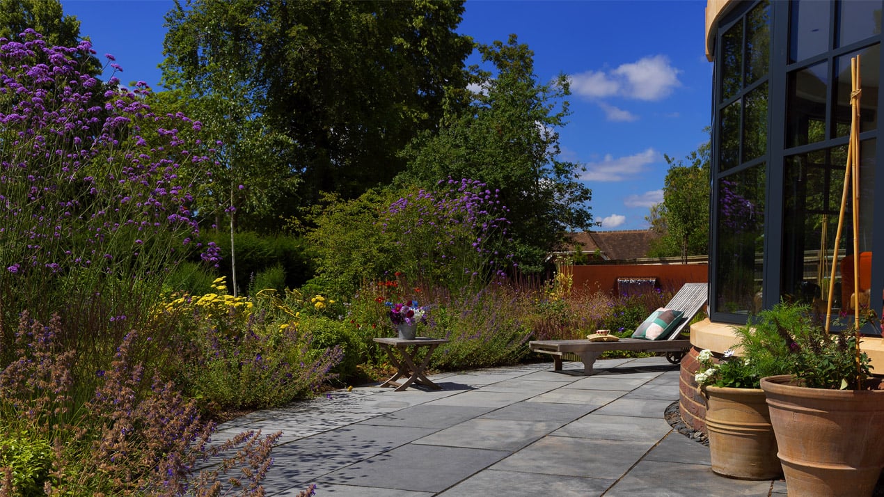 tranquil cottage garden with lounger