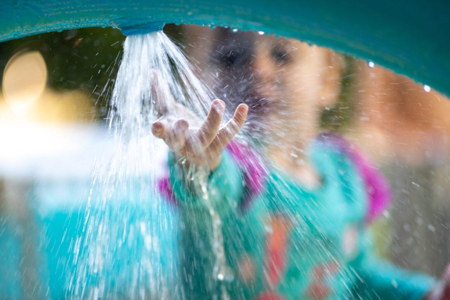 girl playing in water feature