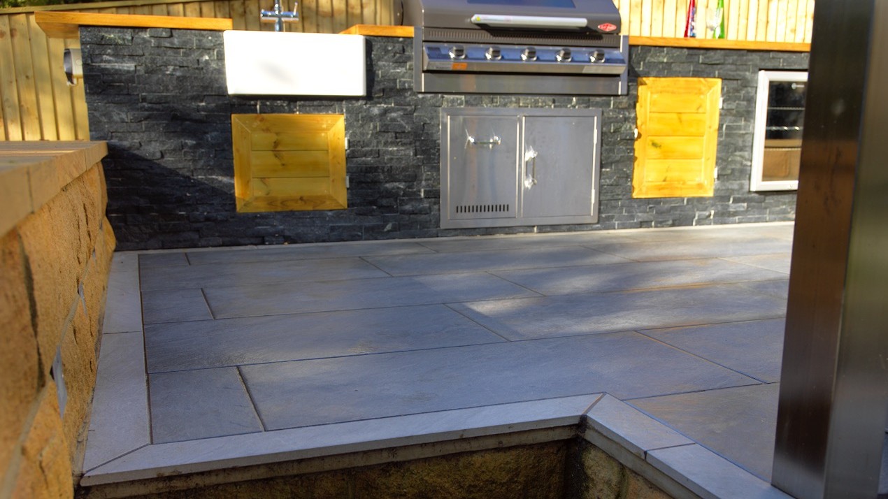 Outdoor kitchen with fridge and grill