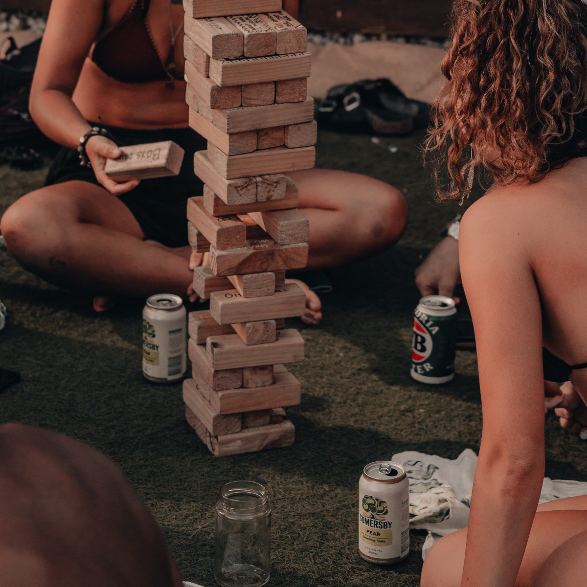 Aussie girls playing jenga drinking VB (the leges)