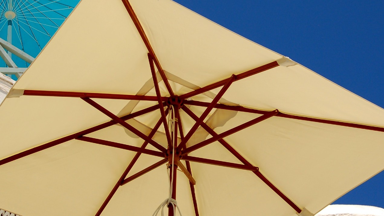 Canvas and wooden framed square parasol.