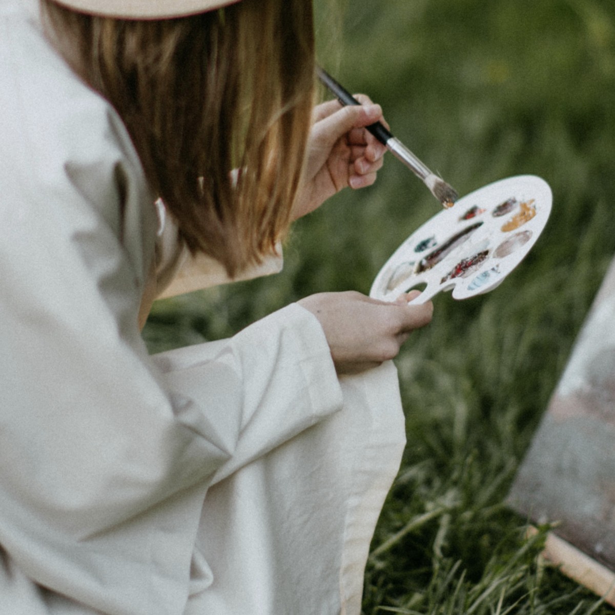 Girl painting with oil pallette