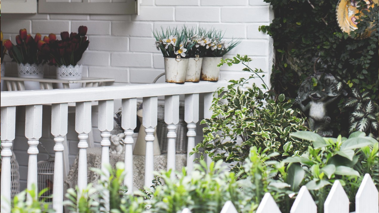 Small garden with fence and planters