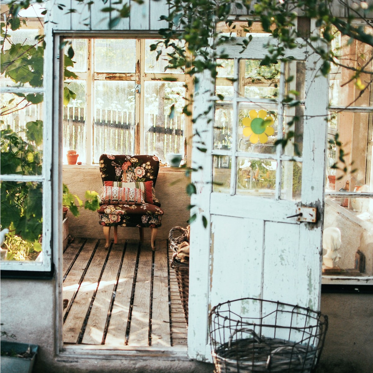 Garden shelter with chair and hanging vines